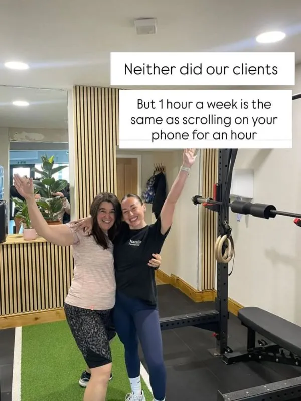 Two members hugging in the gym, captioned: Neither did our clients, but 1 hour a week is the same as scrolling on your phone for an hour