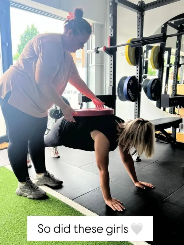 A mum holding her baby at a Strong Mums class, captioned: So was these girls, especially post baby